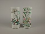 two vases with asian designs on them on a table