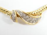 an image of a gold and diamond necklace on a white background