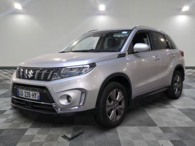the silver suv is parked on a checkered floor in a room
