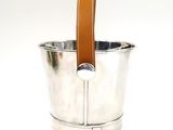 a silver bucket with a leather handle on a white background