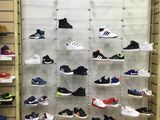many pairs of shoes on display in a shoe store