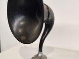 a black and silver speaker sitting on a white table