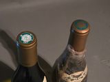 two bottles of wine sitting next to each other on a table