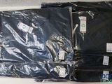 several bags of black clothing sitting on top of a white table