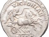 a close up of a coin with a horse and carriage on it