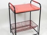 an image of a red metal shelf with two baskets on it