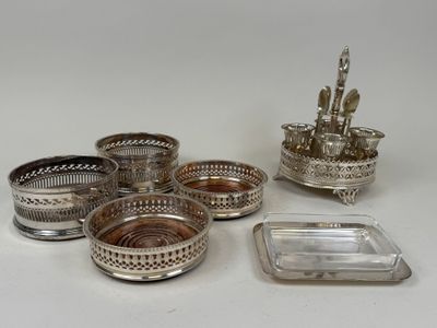 several silver plated dishes and trays on a white surface