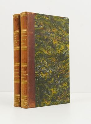two books sitting on top of each other on a white surface