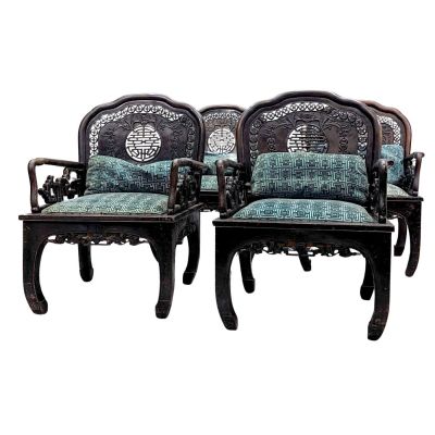 pair of carved wood chairs with blue and green upholstered cushions