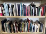 a bookshelf with many books on it in a room