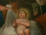 painting of a baby in a manger surrounded by animals and a goat