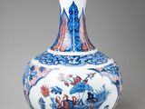 a blue and white vase sitting on a table