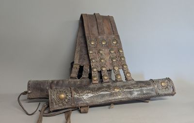 an old wooden chair with metal studding on it
