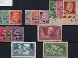 several different colored stamps on a black surface with a white tag
