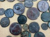 a wooden box filled with lots of old coins sitting on top of a table