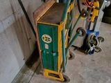 a green and yellow box next to a blue and yellow cart
