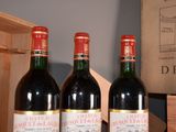 three bottles of wine sitting on a table next to a wooden box
