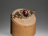 a close up of a wooden box with a ring on top of it