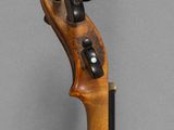 a close up of a violin neck with a wooden handle