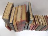 a lot of old books stacked on top of each other