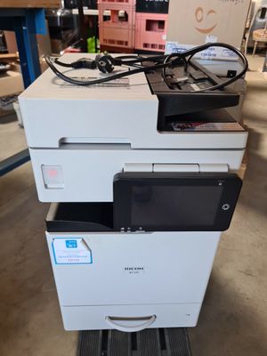 the printer is sitting on top of the cart in the warehouse