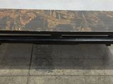 a black and gold coffee table sitting on top of a tiled floor