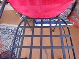 a red chair with a red cushion on top of it