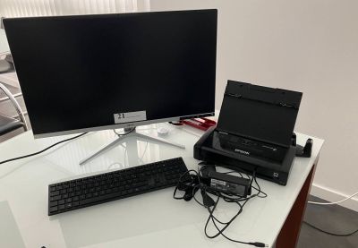a desk with a laptop and a monitor on it