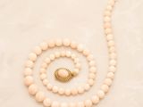 a close up of a necklace and a bracelet on a table