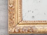 a picture of a gold framed mirror on the wall