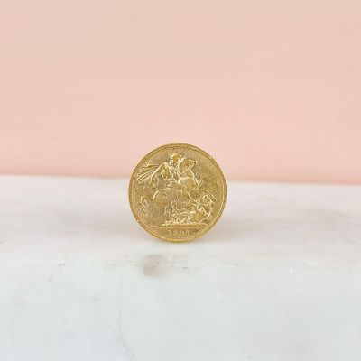 a gold coin sitting on top of a marble counter