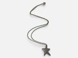 a silver necklace with a star charm on a chain