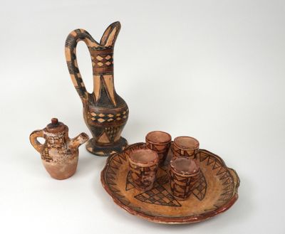 several pieces of pottery are displayed on a white surface