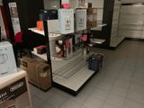 a display of electronics in a store with boxes on the floor