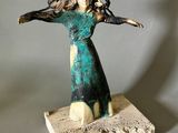 statue d'une femme les bras tendus vers le ciel
