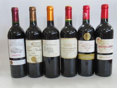 several bottles of wine are lined up on a table