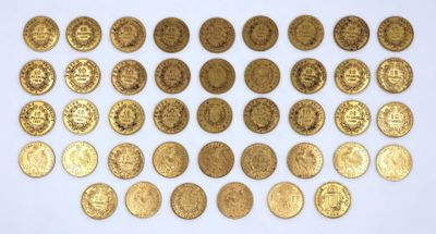 a close up of a bunch of gold coins on a white surface