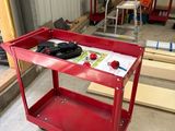 a red work cart in the middle of a room