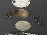 four silver plate bracelets with a chain around them on a black surface