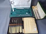 a green case with silverware in it on a table