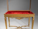 a gold and red table with a mirror on top of it
