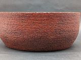 an image of a red bowl sitting on top of a table