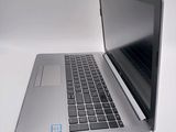 a silver laptop computer sitting on a white surface