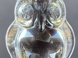 a glass owl figurine sitting on top of a table