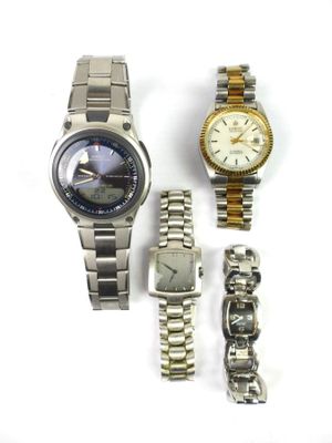 two watches and a watch bracelet are sitting on a white surface