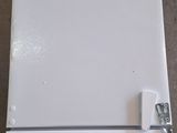 a white refrigerator with a blue handle on the floor
