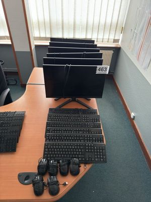 a desk with a keyboard, mouse, and monitor on it