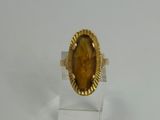 yellow tiger eye stone ring on clear acrylic stand