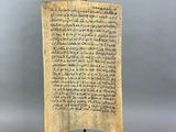 a wooden plaque with writing on it on a stand