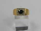 a close up of a gold ring with a blue stone in it